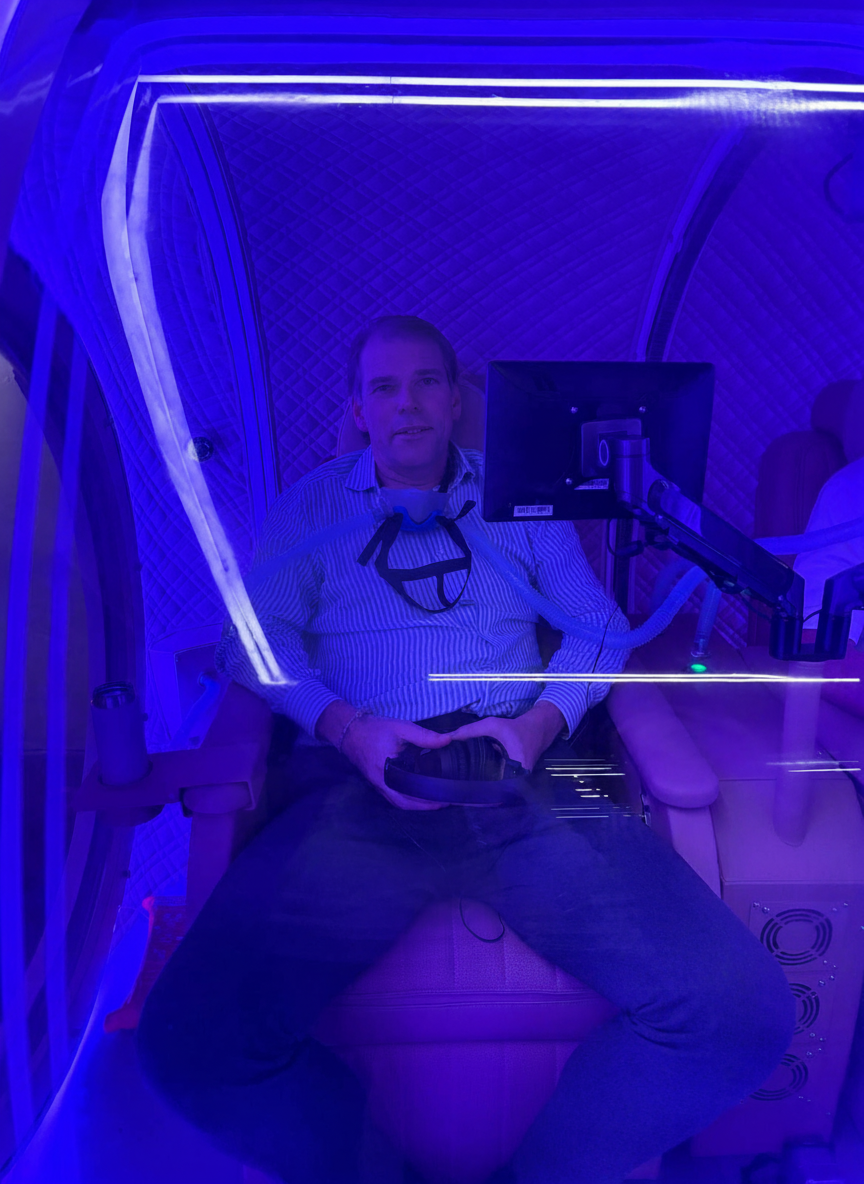 Client relaxing inside HBOT chamber
